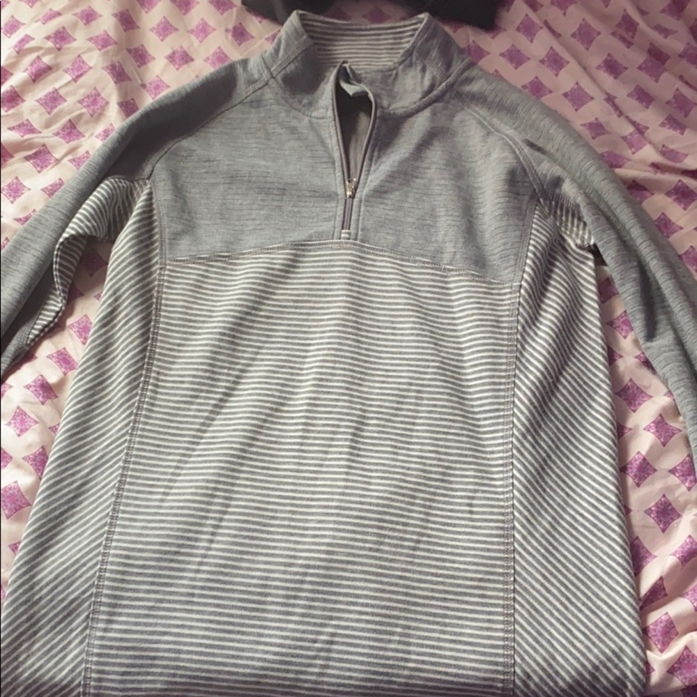 a grey/silver/white zip up sweater